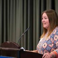 Woman giving speech at podium